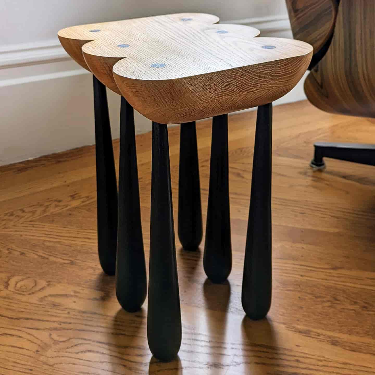 View of shaped side table with six legs